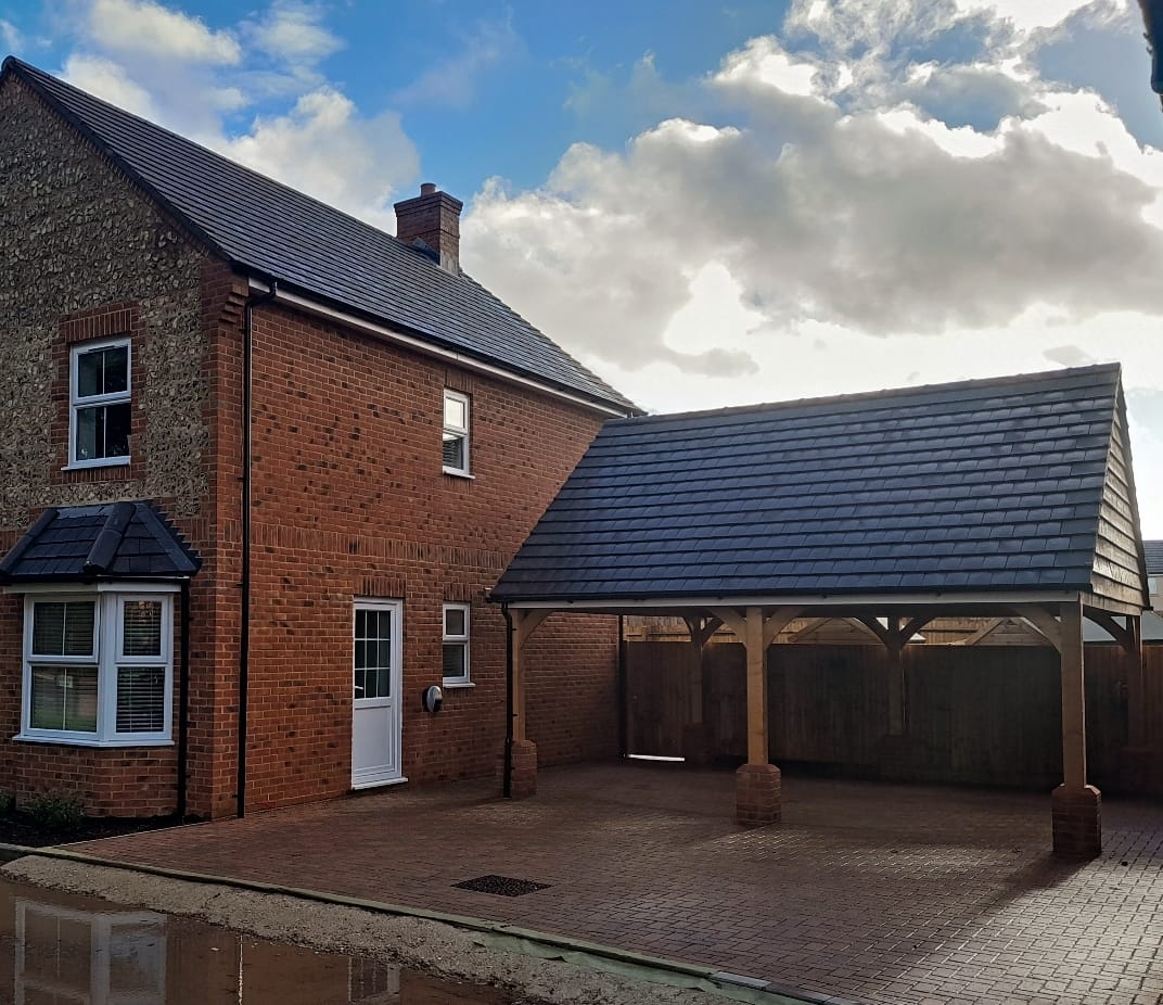 Carpentry work carried out on car ports next to a house for a housing developer